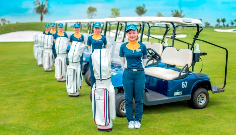 Vietnam golf caddies standing with golf carts – tipping supports their income and service quality