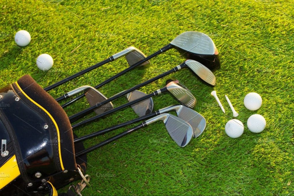 Golf clubs and golf balls on grass before starting a round of golf