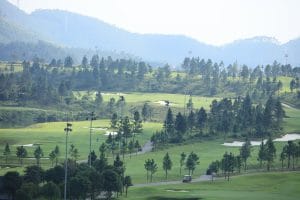 Thanh Lanh Valley Golf Resort fairways framed by pine-covered hills in the Tam Dao mountain range