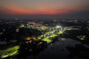 Heron Lake Golf Course & Resort fairways lit for night golf at dusk, beside Dam Vac Lake