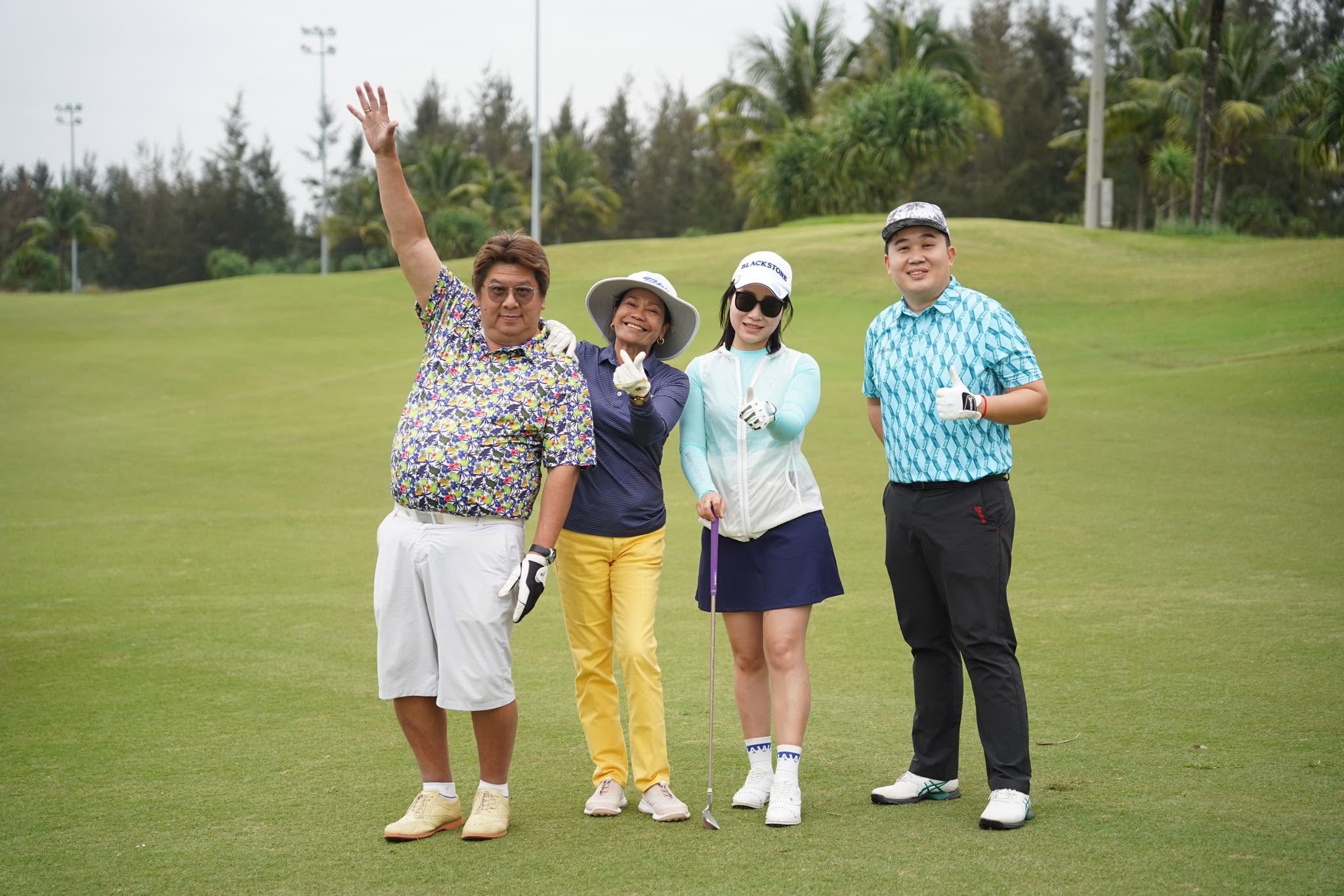 Group of four Asian golfers celebrating on the fairway during a Da Nang golf trip, the kind of long-weekend group booking Filipino golfers make