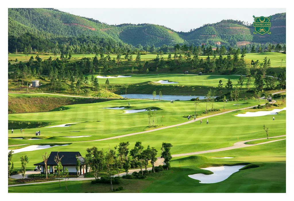 Aerial view of Thanh Lanh Valley golf course near Hanoi, with fairways, a lake and forested mountains behind