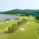 Chi Linh Star Golf & Country Club seen from above, showing the valley layout, lake and forested hills