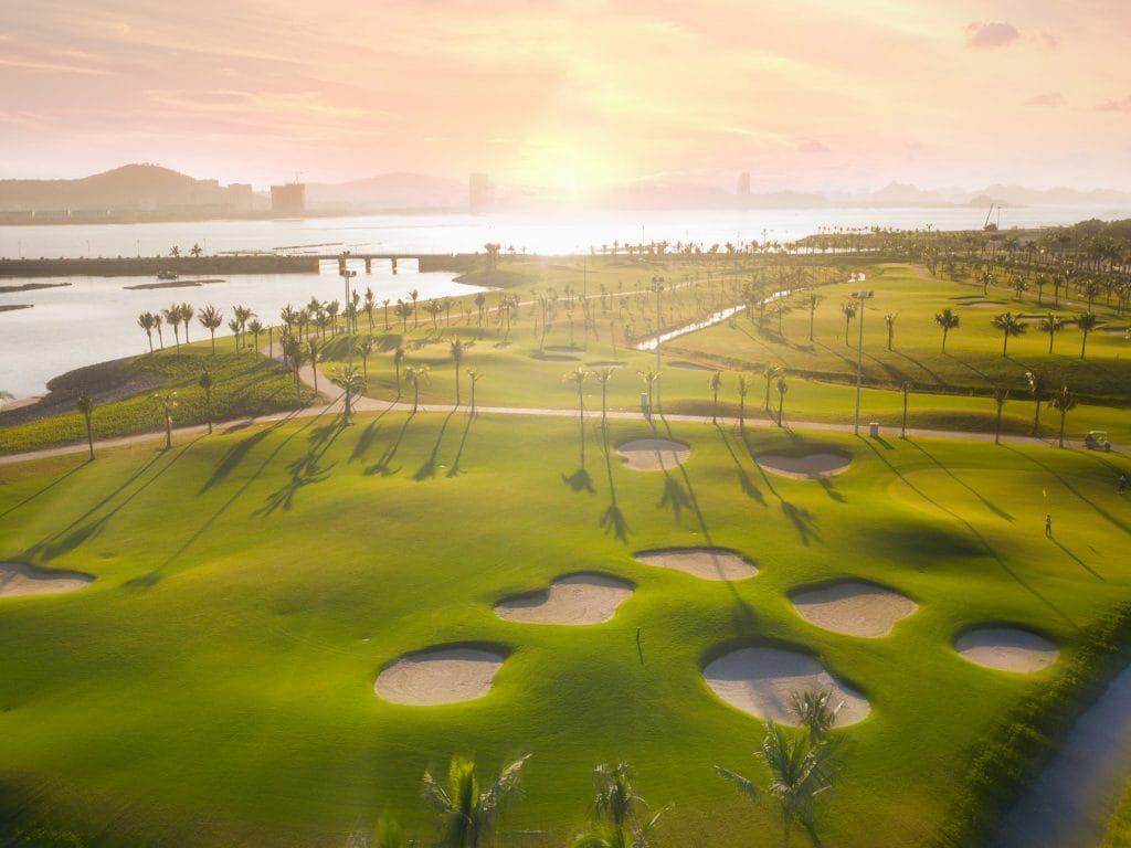 Tuan Chau Golf Resort bunkers at sunrise with Ha Long Bay in the distance