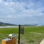 Tuan Chau Golf Resort coastal fairway with palm trees and golf cart