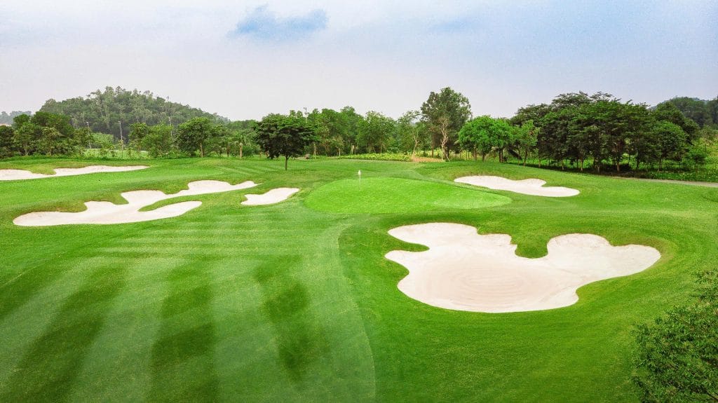 Aerial close-up of flower-shaped white sand bunkers around the green at BRG Legend Hill Golf Resort
