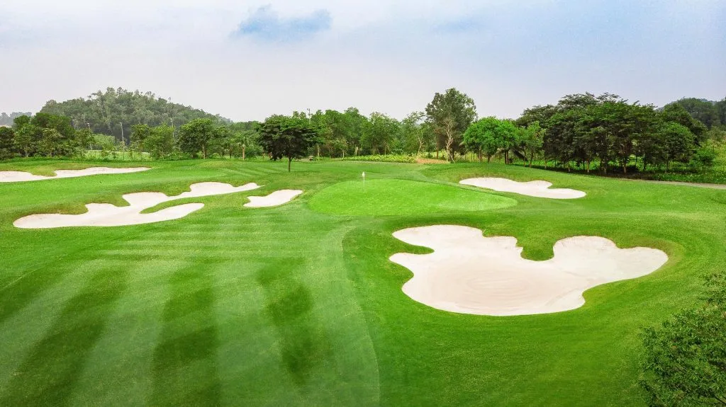 Aerial close-up of flower-shaped white sand bunkers around the green at BRG Legend Hill Golf Resort