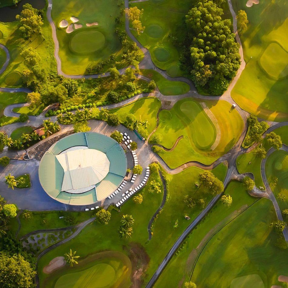 Aerial view of the round clubhouse and surrounding fairways at Chi Linh Star Golf & Country Club