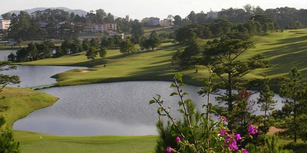 Dalat Palace Golf Club lakes with Da Lat city behind
