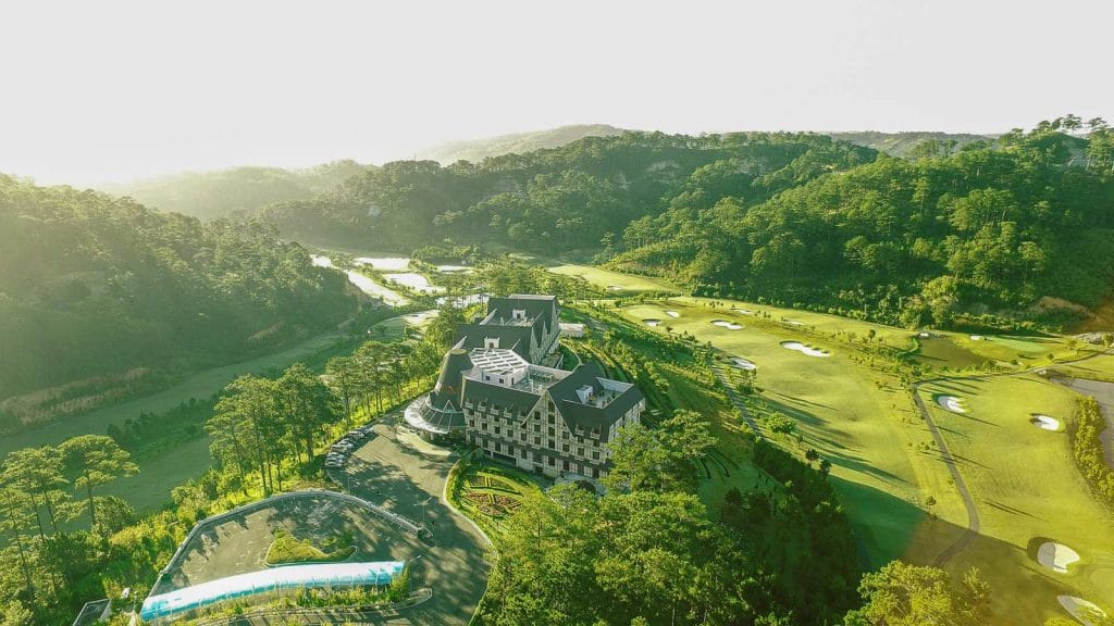 Aerial view of SAM Tuyen Lam Golf Club clubhouse and course in the pine hills of Da Lat