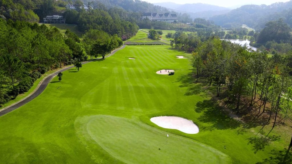 Aerial view of a SAM Tuyen Lam Golf Club fairway and green near Tuyen Lam Lake