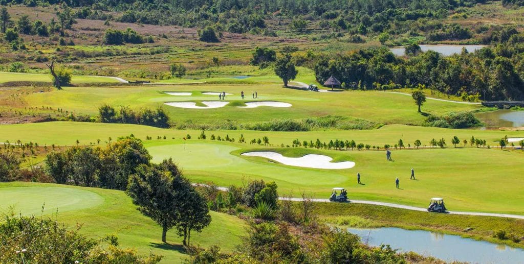 Aerial view of bunkered fairways at The Dalat at 1200 Country Club