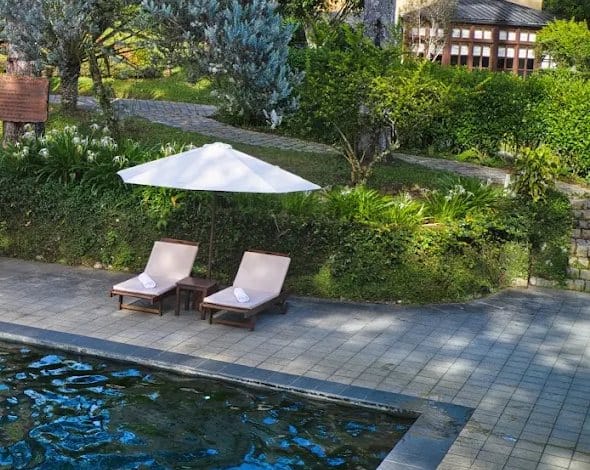 Outdoor heated pool and sun loungers at Ana Mandara Villas Dalat Resort & Spa