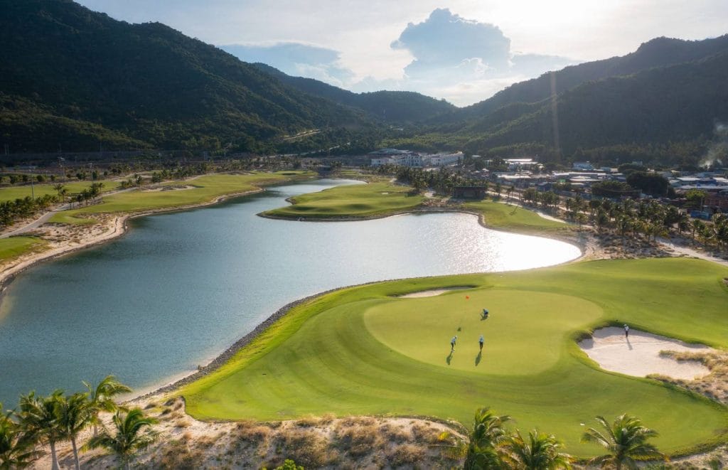 Aerial view of a lakeside green at ANARA Binh Tien Golf Club