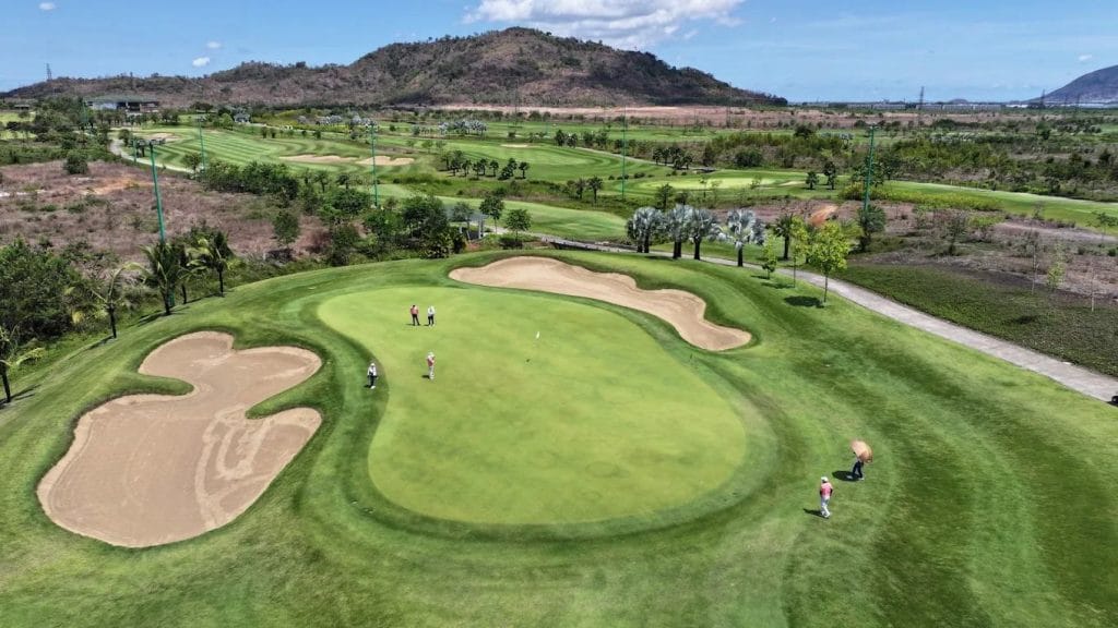 Aerial view of a green and bunkers at Chau Duc Golf Course