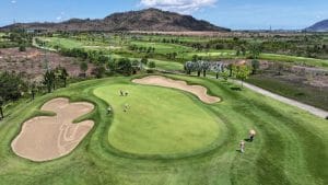 Aerial view of a green and bunkers at Chau Duc Golf Course