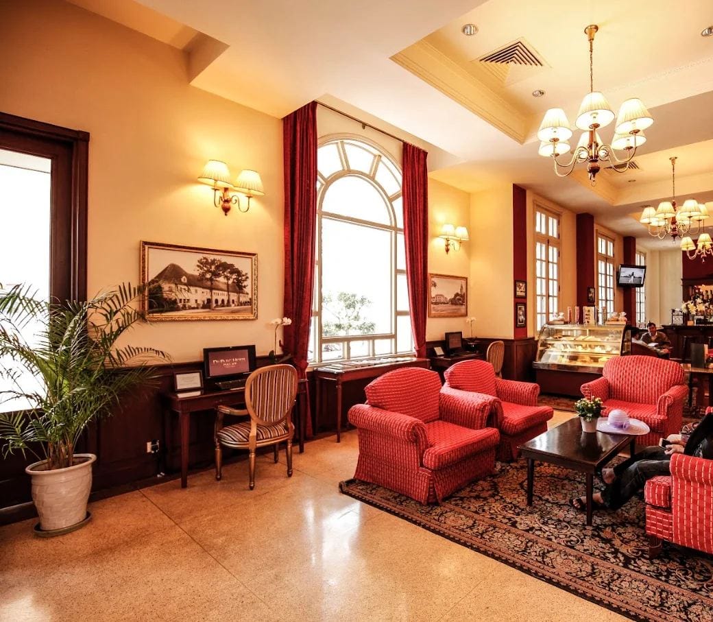 Lobby lounge with red armchairs at Du Parc Hotel Dalat