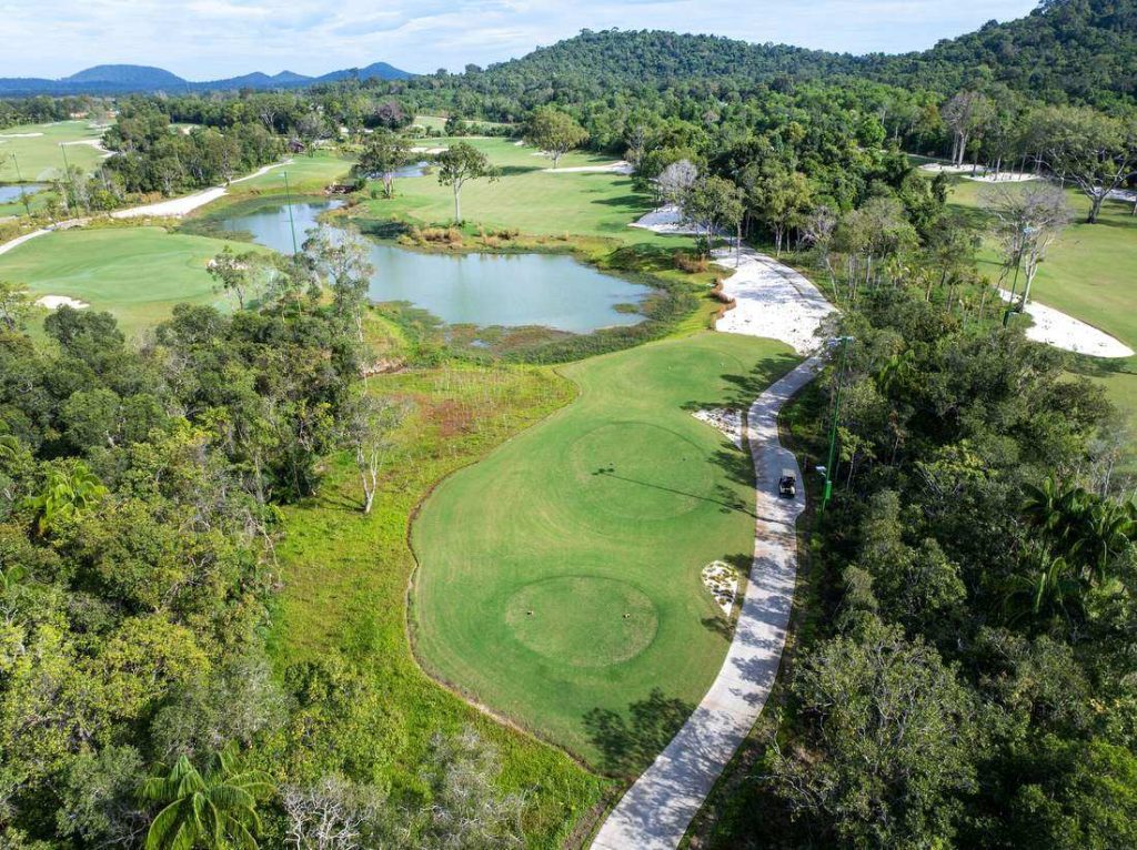 Aerial view of forest holes and a lake at Eschuri Vung Bau Golf Resort, Phu Quoc