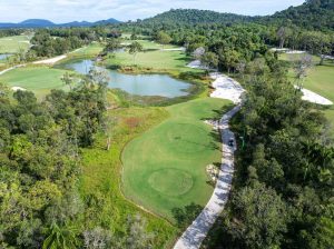 Aerial view of forest holes and a lake at Eschuri Vung Bau Golf Resort, Phu Quoc