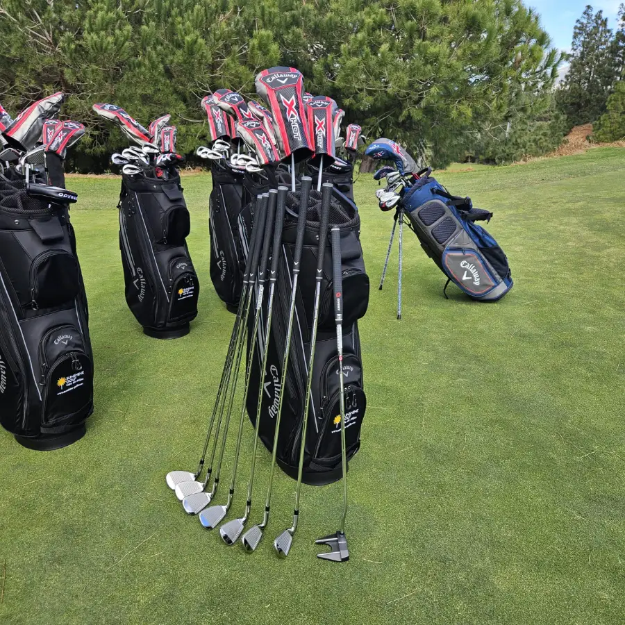 Rental golf club sets with irons, wedges and putter ready at the bag drop