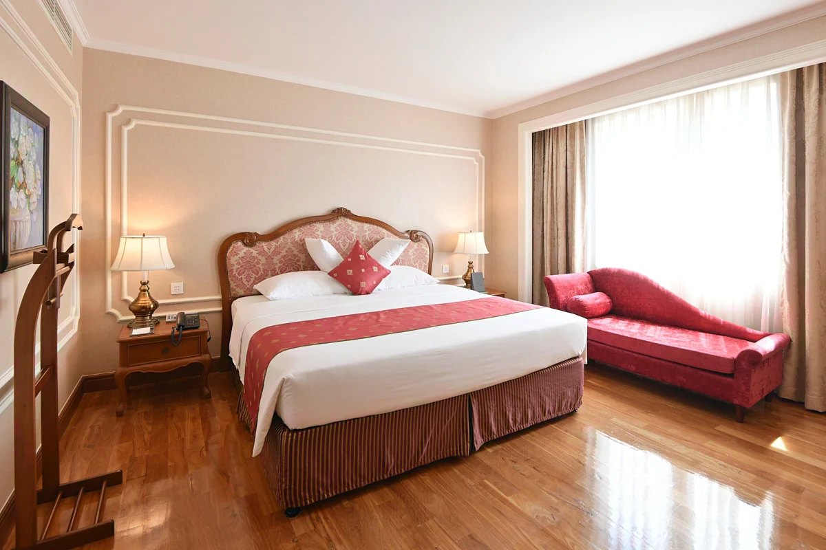 Guest room with wooden floor at Hotel Grand Saigon