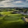 Green guarded by sandy waste bunkers at KN Golf Links Cam Ranh