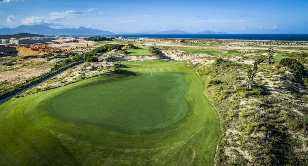 Dune-framed green with sea and mountain views at KN Golf Links Cam Ranh, Nha Trang