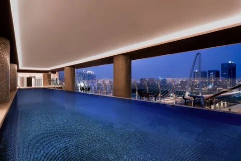 Rooftop lap pool overlooking the Saigon River at Le Méridien Saigon
