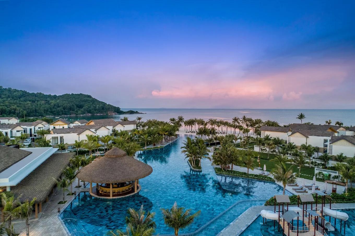 Main pool and thatched pool bar above Khem Beach at New World Phu Quoc Resort