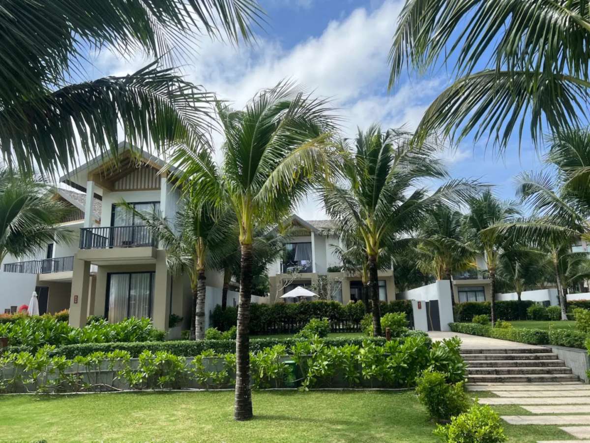 Two-storey pool villas among palm trees at New World Phu Quoc Resort