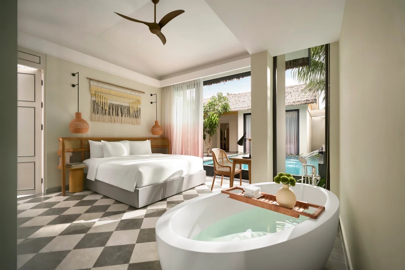 Pool villa bedroom with freestanding bathtub at New World Phu Quoc Resort