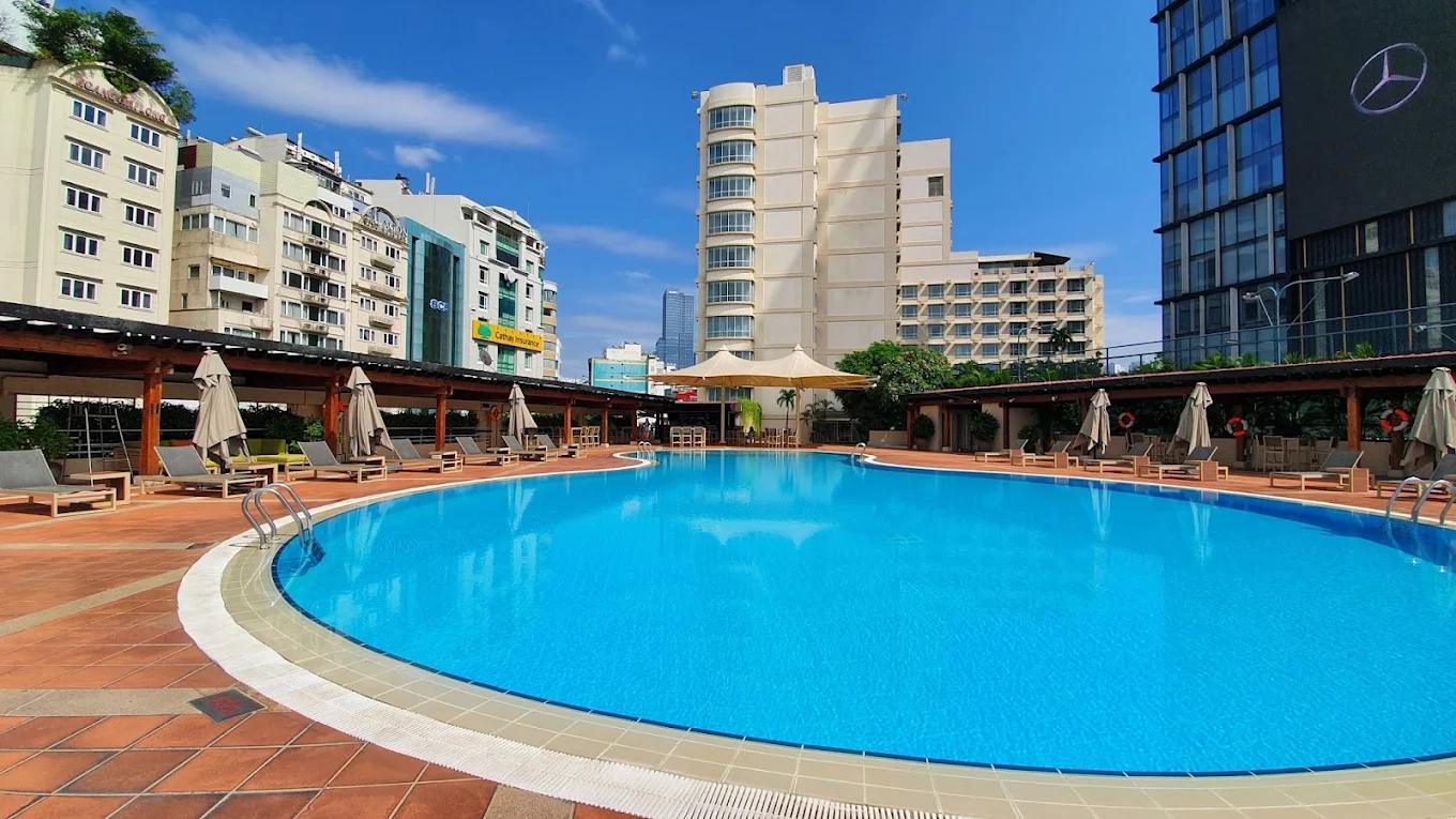 Outdoor pool and sun loungers at New World Saigon Hotel