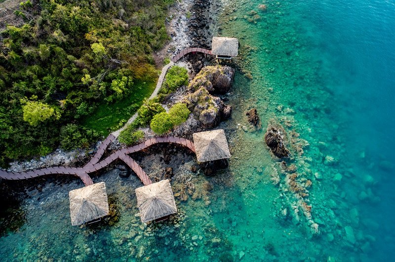 Aerial view of Hon Tre island coastline and clear water in Nha Trang Bay