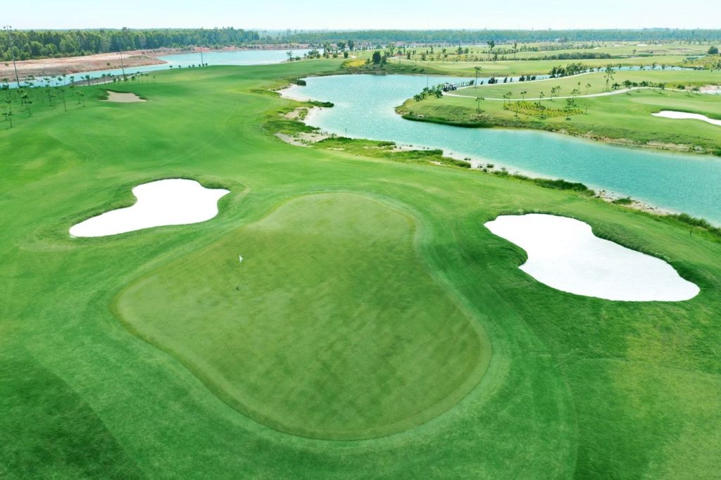 Hole 3 green beside the lake at Royal Long An Golf & Country Club