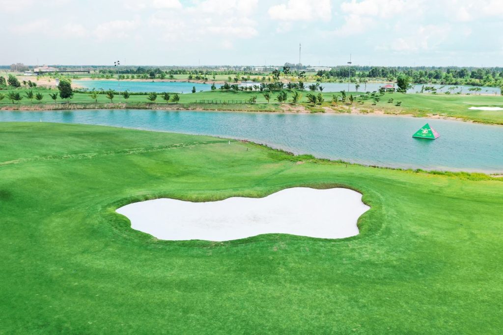Hole 5 with lake carry at Royal Long An Golf & Country Club
