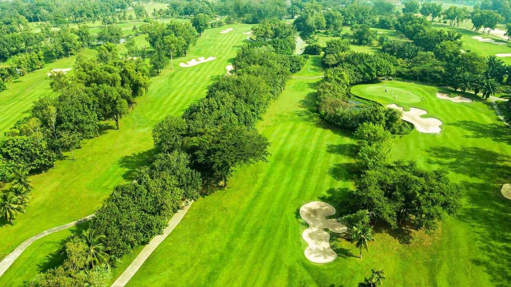 Tree-lined fairways from above at Song Be Golf Resort