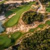 Fairways, a lake and greens set between sand dunes and forest at The Bluffs Grand Ho Tram