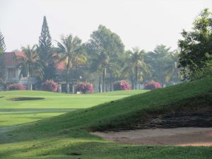 West Course 18th fairway and bunker with the clubhouse behind at Vietnam Golf & Country Club