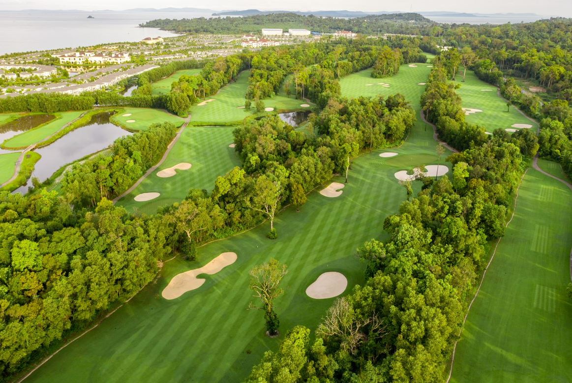 Vinpearl Golf Phu Quoc fairways surrounded by forest from above Vinpearl Golf Phu Quoc fairways surrounded by forest from above