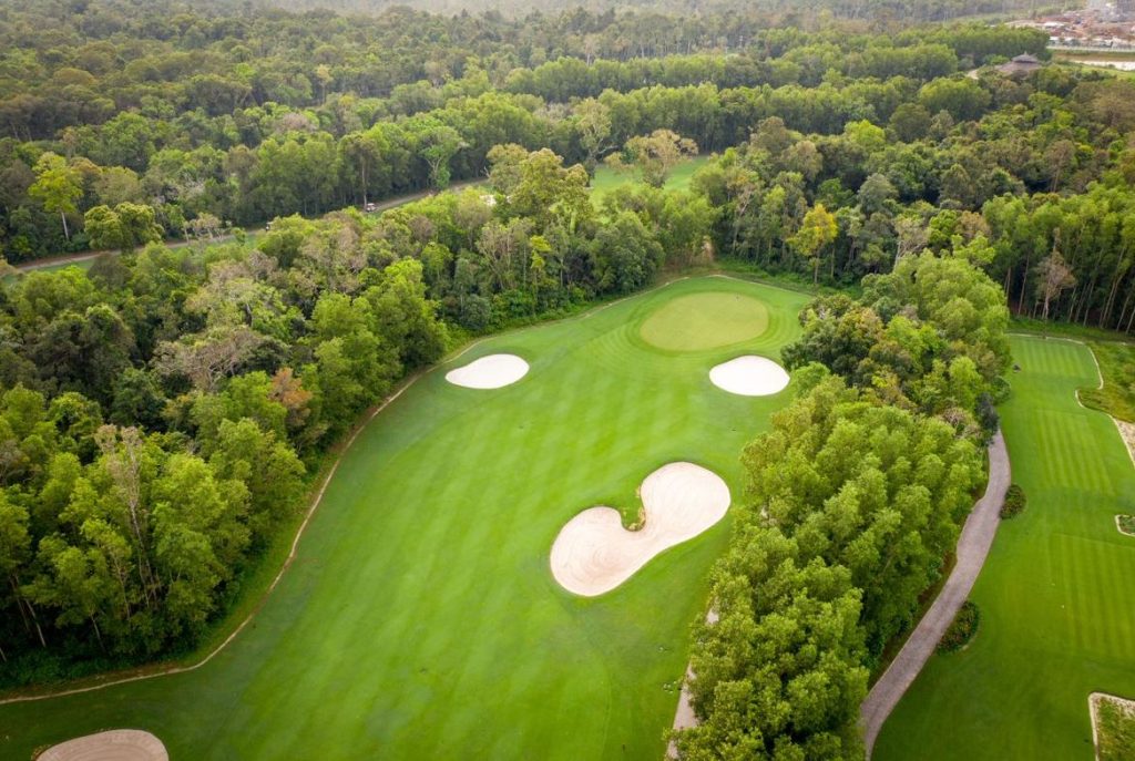 Aerial view of a green guarded by bunkers at Vinpearl Golf Phu Quoc