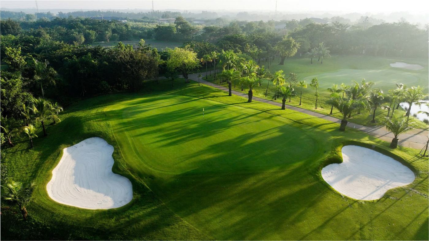 Bunkers and palms beside the fairway at West Lakes Golf & Villas